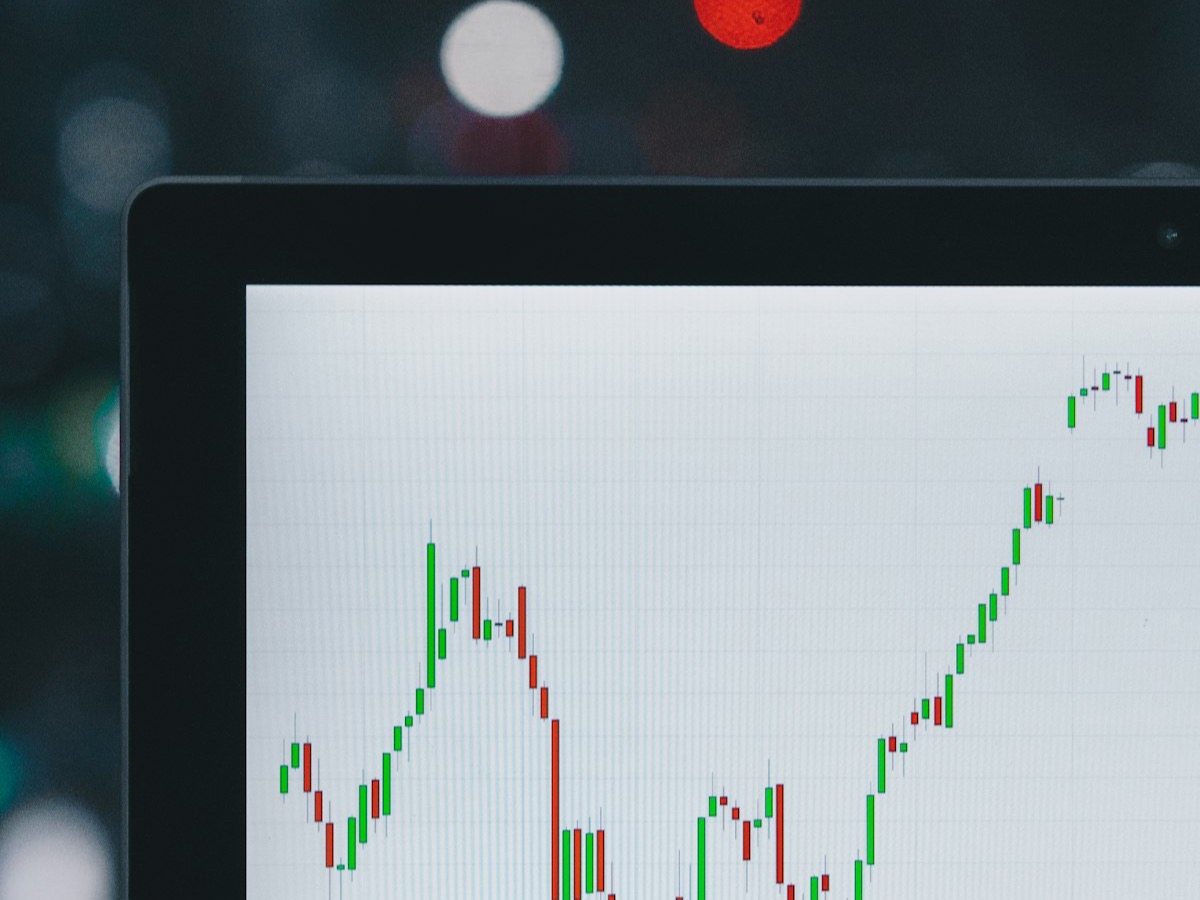 Financial market data charted on a screen in a darkened room